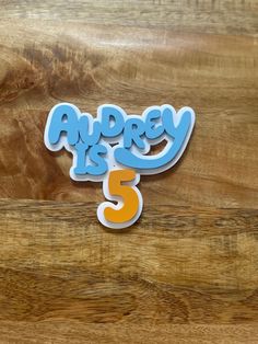 there is a sign that says andyy is 5 on the side of a wooden table