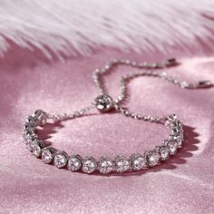 Create a sensation with this fashion-forward tennis bracelet. This graceful look features a fluid line of sparkling round stones. This classic, elegant and timeless look blends sophistication with radiance and sparkle. Crafted in high-polished sterling silver, this bracelet is sure to add a touch of elegance and style to any outfit, from business casual to formal wear.Carat Weight: 5.9 ctStone Size: 3.5 mmNumber of Stones: 20 Stone Shape: RoundStone Color: Diamond WhiteWeight: 7.92 gWidth: 6 mmH Diamond White Tennis Bracelet With Diamond Accents For Party, Elegant Diamond Bangle Bracelet With Rhinestones, Elegant Crystal Diamond Bracelet With Sparkling Stones, Diamond White Cubic Zirconia Tennis Bracelet For Party, Elegant Cubic Zirconia Tennis Bracelet For Party, Elegant Rhinestone Diamond Bangle Bracelet, Wedding Tennis Bracelet With Sparkling Round Cut Stones, Dazzling Brilliant Cut Tennis Bracelet, Prong Set Diamond Bracelet