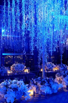 an outdoor event with white flowers and blue lights