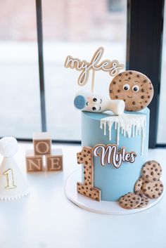 a cake decorated with cookies and icing on a table