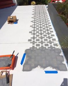 the cement is being laid on top of the house to make it look like it has been painted