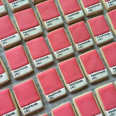 some cookies with pink icing are arranged in rows