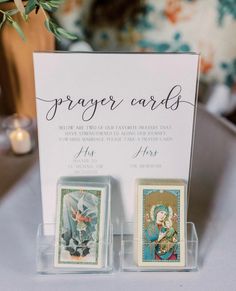 two playing cards are on display in front of a card holder with the words prayer cards