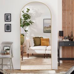 a living room filled with furniture and a large mirror on the wall next to a couch