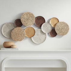 Bring nature indoors, adding inspiring earth-inspired charm and a mix of textures and neutral finishes. This modern coastal metal disk wall art from the Tempus collection by Dahlia Studios gathers a spread of circular metal disks in a smattering of versatile finishes including matte gold, bronze, and white-washed. Seagrass details on some disk elements suggest a coastal aesthetic suitable for updated contemporary design schemes devoted to relaxation and simplicity. Hand painting and intricate de Grey Black And Rust Basket Wall Art, Dyi Costal Wall Art, Wall Rattan Art, Large Rattan Wall Art, Three Piece Wall Art Boho, Wicker Basket Wall Art Modern, Wall Basket Decor Ideas, Dining Room Accents