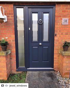 a blue front door on a brick building