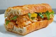 there is a sandwich with shrimp and vegetables in it