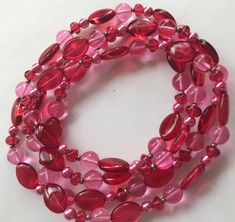 ON SALE Vintage red pink long fashion glass beaded necklace in excellent vintage condition. Measures 44 inches long. Long Pink Beaded Necklace With Faceted Beads, Pink Beaded Necklace For Valentine's Day, Runway Jewelry, Desert Hot Springs, Stylish Necklace, Month Flowers, Birth Month Flowers, Rhinestone Bracelet, Pink Rhinestones