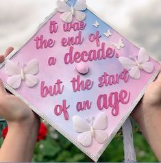 someone is holding up a graduation cap with butterflies on it that says, it was the end of a decade but the start of an age