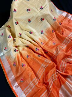 Pure Linen By linen Saree in Orange and Beige Colors with Floral Embroidery Work throught the Body of the Saree and Zari Work on the Pallu and borders. Comes with Beautiful Tassels attached. Item : Saree Color : Orange and Beige Base Fabric : Pure Linen Blouse piece : Comes with un-stitched Blouse piece. Blouse material : Pure Linen Fall & Edging : Comes with Fall and edging (Pico) done Disclaimer: Slight variation in actual color vs. image is possible due to the screen resolution. Summer Chanderi Embroidered Fabric, Summer Chanderi Fabric With Floral Embroidery, Embroidered Raw Silk Dupatta For Spring, Summer Floral Embroidered Chanderi Fabric, Summer Traditional Wear With Dori Work, Summer Embroidered Dupatta, Traditional Slub Silk Fabric With Floral Embroidery, Summer Zari Work Saree, Traditional Linen Saree With Zari Work