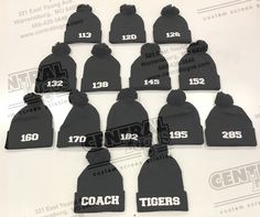 twelve black beanies with white numbers and the number one on each team's side