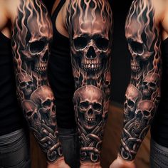 a man's arm covered in tattoos with skulls and flames on the arms,