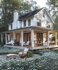 a large white house sitting on top of a lush green field