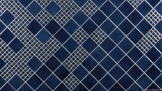 an abstract blue and white tile pattern with diamond shapes on the bottom right hand corner