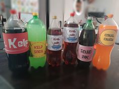 several bottles of soda sitting on top of a table next to each other, all labeled with ketchup