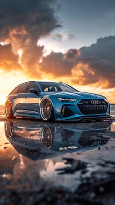 an audi car parked on the beach at sunset with its reflection in the wet sand