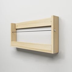 a wooden shelf mounted to the side of a wall