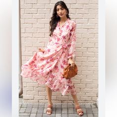 A Floral Print And Long-Hanging Chiffon Skirt Brings Captivating Elegance To This Wrap Dress Style Midi! This Sweet, Summery Dress Is Styled In A Long Sleeve Silhouette, Ruffle-Topped Shoulders, V-Neckline, And A Hi-Lo Skirt. Fit Is True To Size. Pink, Peach, Orange With Gold Metallic Flecks Lined Self And Lining: 100% Polyester Hand Wash Cold With Similar Colors, Lay Flat To Dry Ruffle Shoulders Elastic Encased Cuff 20.5” Pit To Pit 45” Length Front 53” Length Back Waist Is Very Adjustable Size Feminine Long Sleeve Pink Maxi Dress, Feminine Pink Long Sleeve Maxi Dress, Pink Long Sleeve Maxi Dress For Casual Wear, Pink Long Sleeve Maxi Dress For Day Out, Elegant Pink Floral Dress For Daywear, Elegant Pink Floral Dress For Vacation, Pink Long Sleeve Feminine Floral Dress, Feminine Long Sleeve Floral Dress For Day Out, Feminine Pink Midi Dress For Brunch