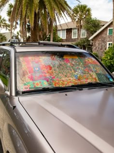 a car parked in front of a palm tree