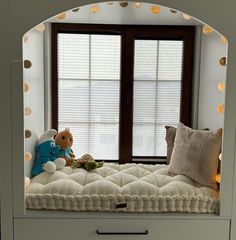 a window seat with a stuffed animal on it