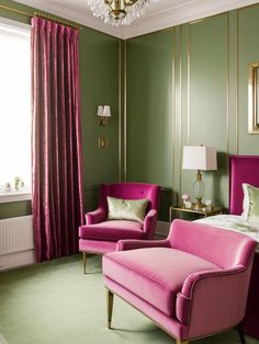 a bedroom with green walls, pink chairs and a chandelier hanging from the ceiling