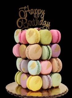 a birthday cake made out of macaroons with the words happy birthday on top