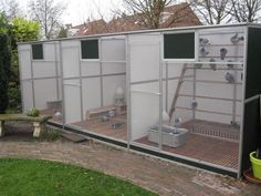 an outdoor chicken coop in the middle of a yard