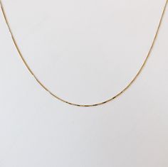 "+ HARMONY GOLD CHAIN + A very sleek 14k Yellow Gold box chain necklace that is perfect to wear as is or put a charm on it. Chain is a tiny baby box chain, and it moves on your neck to catch the light. Staple for everyday. + 14KY Gold box chain. + 0.5mm chain + Approx. 18\" chain (please convo me for shorter measurement) + Comes in a box. + Please allow 3-5 business days to ship + Please note all Mantle 14k gold pieces are made-to-order. In stock items ship within 3-5 business days. Please allow Everyday Gold-tone Box Chain Jewelry, Delicate Yellow Gold Box Chain Necklace, Dainty Gold-plated Box Chain Necklace, Minimalist Yellow Gold Chain Necklace, Tarnish Resistant, 14k Gold-filled Yellow Gold Box Chain Necklace, Delicate Gold Chain, Chain Necklace Gold, Baby Box, Casual Jewelry