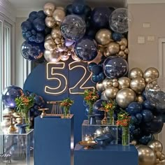 balloons and decorations are displayed in front of a sign that reads 522 on it