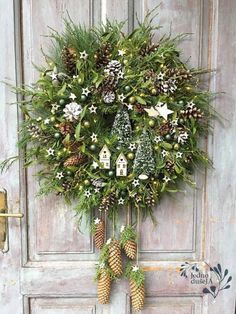 a wreath with pine cones and evergreens hanging on the front door to decorate it