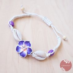 Twinkle Plumeria Purple Friendship Bracelet - Made In Hawaii Cowrie Shell Beaded Bracelets As Gift, Bohemian Shell Friendship Bracelets Handmade, Adjustable Cowrie Shell Friendship Bracelets For Vacation, Adjustable Cowrie Shell Beachy Jewelry, Adjustable Shell Friendship Bracelets For Vacation, Adjustable Bohemian Shell Friendship Bracelets, Beachy Cowrie Shell Beaded Bracelet As Gift, Beachy Cowrie Shell Beaded Bracelet For Gift, Bohemian Cowrie Shell Bracelet Gift