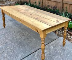 a wooden table sitting on top of a sidewalk