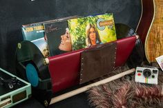 an old record player and other musical equipment are on display in front of a guitar case