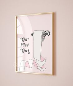 a pink wall with a gold frame hanging on it's side and an illustration of a girl holding a roll of toilet paper