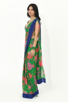 Jade green saree with contrast border, floral prints and sequin embellishments. Paired with a multi color blouse with back tie-up, butti prints and golden coin tassels. - Aza Fashions Green Pre-draped Saree With Printed Motifs, Green Chanderi Pre-draped Saree For Puja, Green Pre-draped Saree With Dupatta, Green Chanderi Choli With Traditional Drape, Designer Green Lehenga With Printed Motifs, Green Bollywood Saree With Sheer Dupatta, Green Sharara With Printed Motifs For Wedding, Green Bollywood Style Pre-draped Georgette Saree, Green Printed Sharara For Wedding