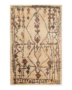 an antique rug with various colors and patterns