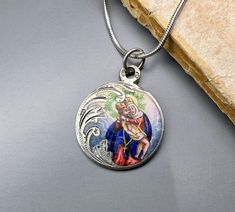 A magnificent antique silver enamel Pieta medal, petite Austrian enamel amulet on a 16 inch long sterling chain, rare Virgin Mary Catholic charm, very nicely done, in good condition, ideal for strength and protection necklace, would make a nice gift for someone special! Comes with approx. 16 inch long 925 silver necklace (see photo 5)! Material: solid silver, enamel Total weight: 6.6g Measures: approx. 22 mm (0.8 inch) in diameter PLEASE LOOK AT THE PICTURES, THEY ARE PART OF THE DESCRIPTION AND ARE THE ACTUAL ITEM YOU WILL RECEIVE. ALL OUR ITEMS ARE IN WORN, VINTAGE CONDITION. Oval Engraved Enamel Necklace, Antique Engraved Enamel Necklace, Enamel Medallion Necklace With Hallmark, Victorian Silver Enamel Jewelry, Victorian Engraved Enamel Necklaces, Silver Enamel Jewelry With Vintage Charm, Vintage Nickel-free Enamel Necklaces, Antique Silver Enamel Necklace, Antique Silver Enamel Necklaces