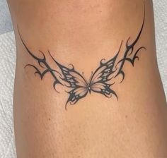 a woman's stomach with a butterfly tattoo on it