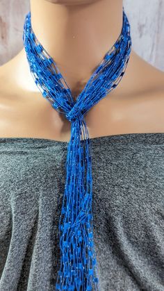 *A beautiful holiday gift* This simple yet stunning blue silver sassy necklace scarf is 48 inches long handmade using 9 strands of blue silver laddere yarn.Add a pop of color to your everyday wardrobe,. this beautiful blue silvery color goes with just about everything.can easilly go from work to play with this eye catcher. This simple design makes it easy to dress up or down for any occasion, work or a night out. This elegant and charming scarf necklace is lightweight and looks great with any outfit a versatile look to enhance your style buy it for yourself a loved one or a friend this piece is a great holiday gift. *My goal is to make sure you receive exactly what you're looking for and for your experience to be a special and memorable one. I am ready to help you with your jewelry purchas Blue Lariat Necklace For Party, Blue Lariat Jewelry For Party, Ladder Yarn Necklace, Ladder Yarn, Necklace Scarf, Yarn Necklace, Scarf Necklace, Blue Necklace, Minimalist Necklace