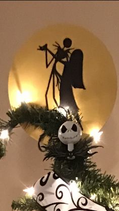 an ornament is hanging on the side of a christmas tree