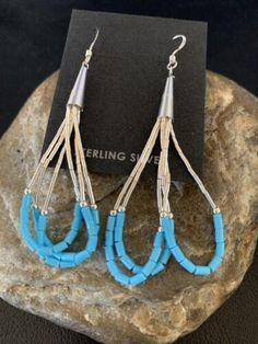 * Beautifully Handmade and original these Blue Turquoise Dangle Liquid Silver Heishi Earrings can add a look of elegance with any casual attire. * They are in Sterling Silver. * Length 2" * Free Gift Pouch with Purchase * Made in USA Please contact seller for any questions and concerns. We hope you have a great experience with us and hope for an awesome review. Southwestern Blue Earrings For Pierced Ears, Southwestern Style Blue Earrings For Pierced Ears, Southwestern Style Blue Pierced Earrings, Southwestern Style Blue Beaded Earrings, Blue Teardrop Dangle Earrings, Blue Southwestern Style Earrings For Gift, Southwestern Blue Earrings For Gift, Turquoise Drop Chandelier Earrings With Ear Wire, Southwestern Blue Earrings With Ear Wire