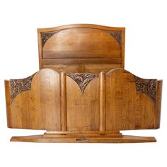 a wooden bed frame with intricate carvings on the headboard and foot board, against a white background