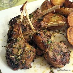 some meat and potatoes on a white plate