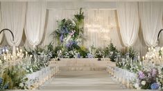 the aisle is decorated with flowers and candles