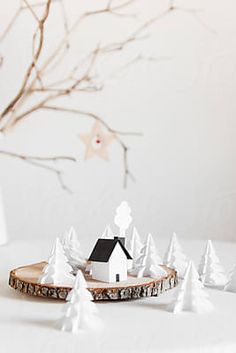 a small white house sitting on top of a table