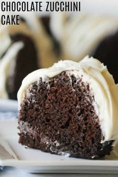 a chocolate zucchini cake on a plate with white frosting