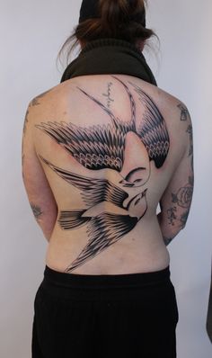 a woman with a bird tattoo on her back