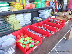 a table filled with lots of different types of candy in bins next to each other