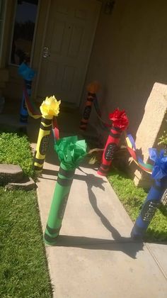 the fire hydrant has been decorated with ribbons on it's sides and is in front of a house