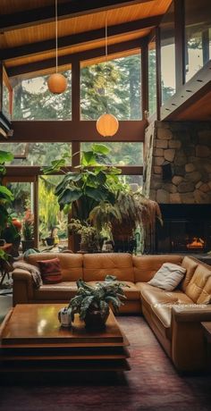 a living room filled with lots of furniture and plants on top of it's walls